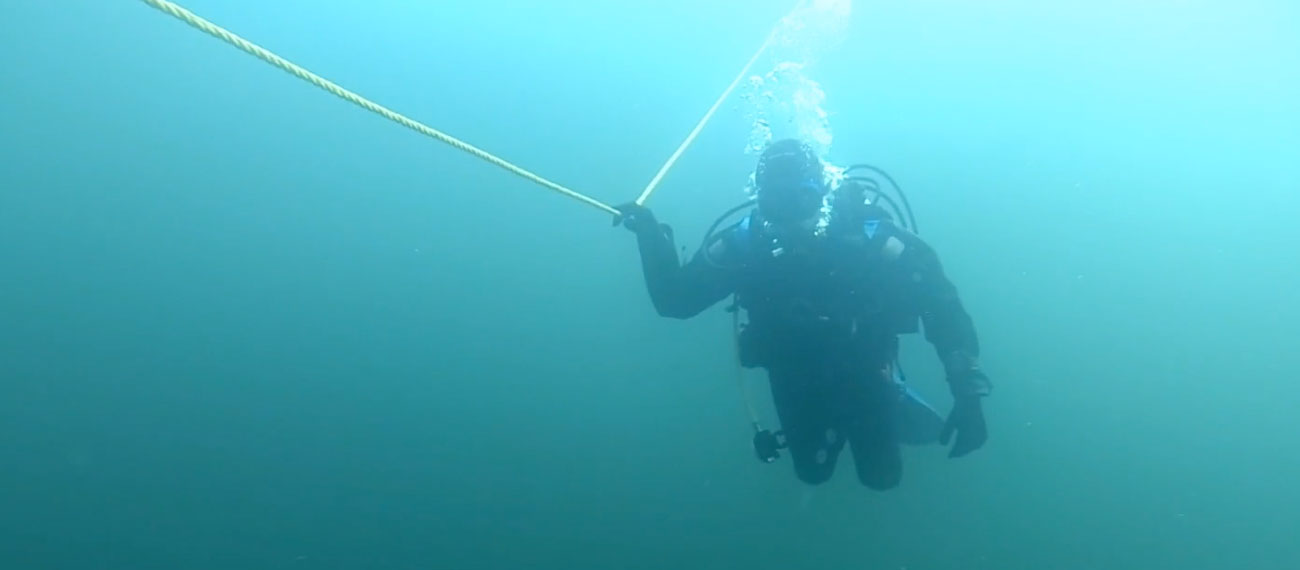 Diver installing submerged mussel farm
